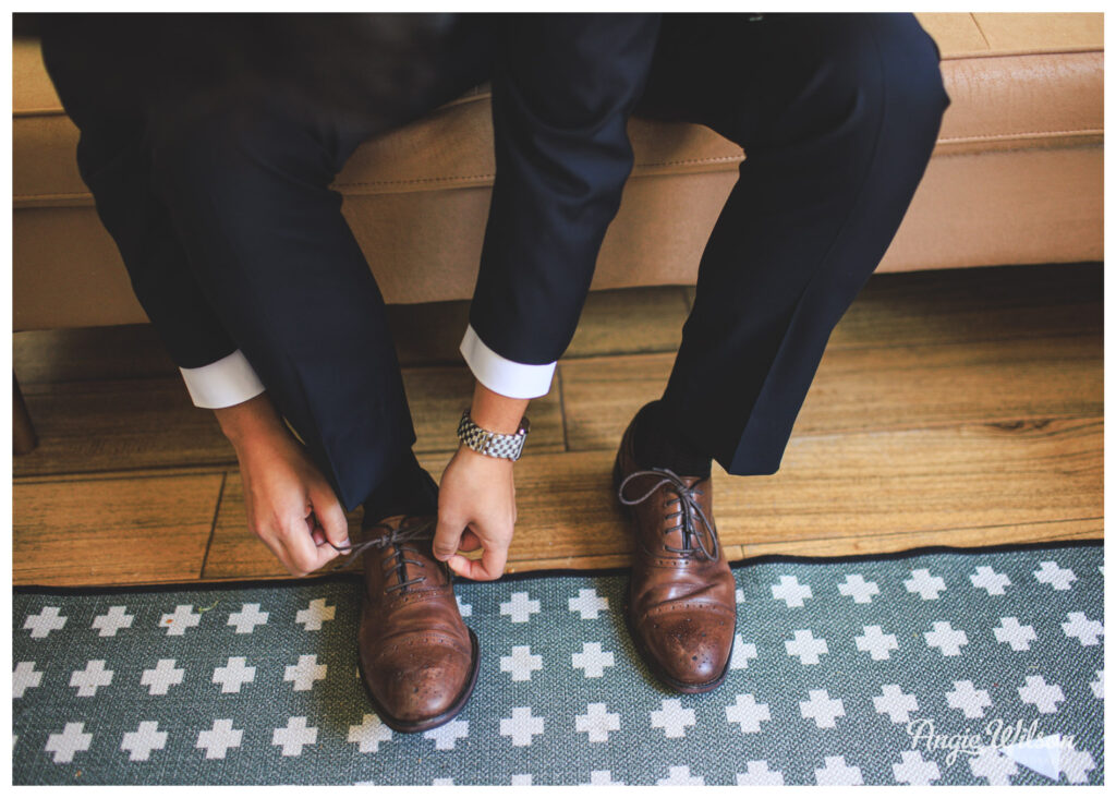Groom putting on shoes at the Lyons Farmette