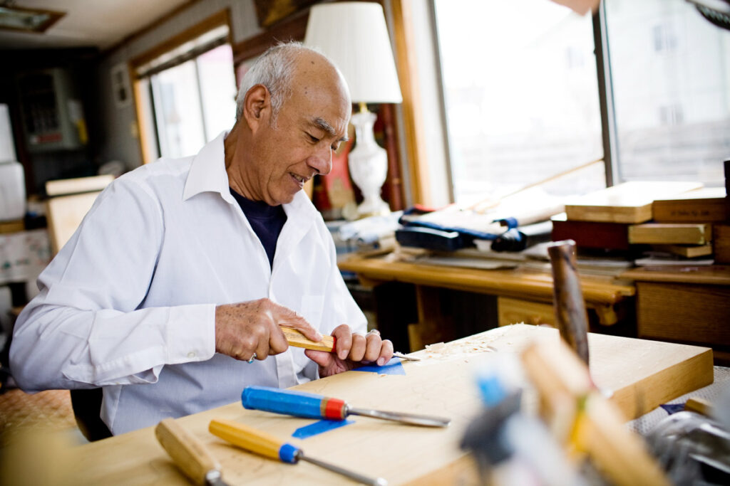 man wood carving editorial photography